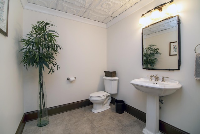 bathroom featuring sink, tile patterned floors, and toilet