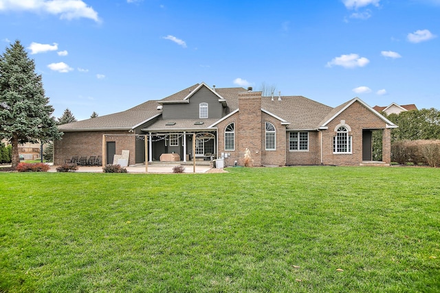 rear view of property with a patio area and a lawn