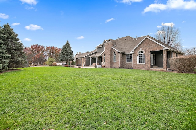 rear view of property with a lawn