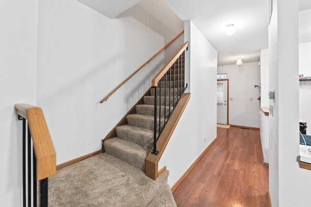 stairway featuring hardwood / wood-style flooring