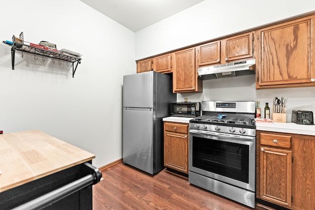 kitchen with dark hardwood / wood-style floors and appliances with stainless steel finishes