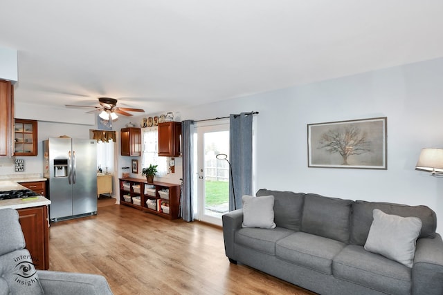 living room featuring light hardwood / wood-style flooring and ceiling fan