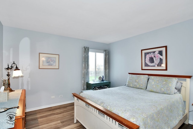 bedroom with hardwood / wood-style flooring