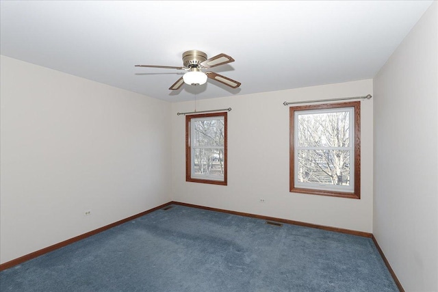 carpeted spare room with ceiling fan