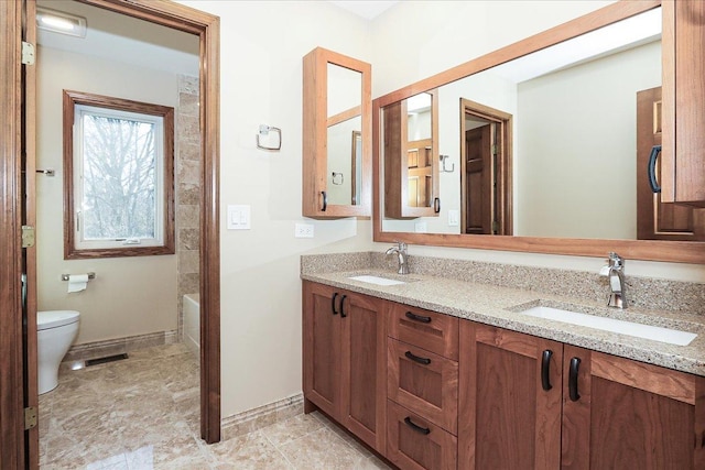 bathroom featuring vanity and toilet