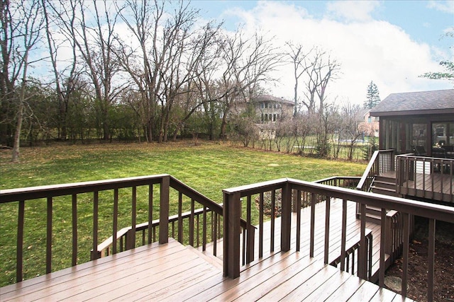 deck featuring a yard and a sunroom