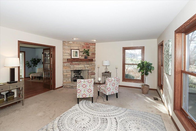 sitting room featuring light colored carpet and a fireplace