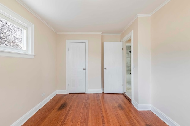 unfurnished bedroom with light wood-type flooring and ornamental molding