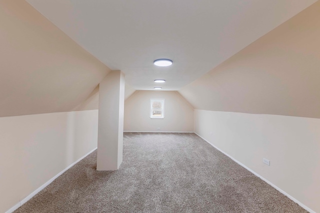 bonus room featuring carpet floors and vaulted ceiling