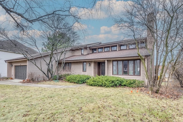 view of front of house with a front yard and a garage