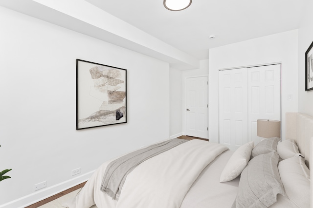 bedroom featuring hardwood / wood-style floors and a closet