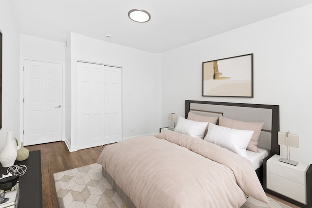 bedroom with a closet and dark hardwood / wood-style floors