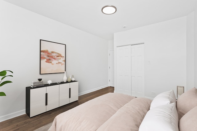 bedroom with a closet and dark hardwood / wood-style flooring