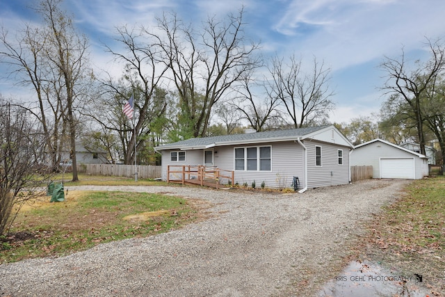 view of front of house featuring an outbuilding, a garage, and a wooden deck