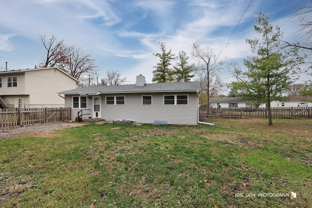 back of property featuring a lawn