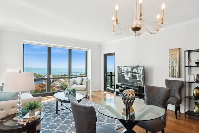 living room with plenty of natural light, a water view, wood-type flooring, and ornamental molding