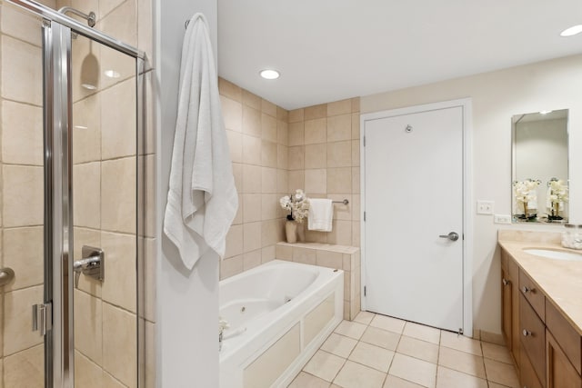 bathroom with tile patterned flooring, vanity, independent shower and bath, and tile walls