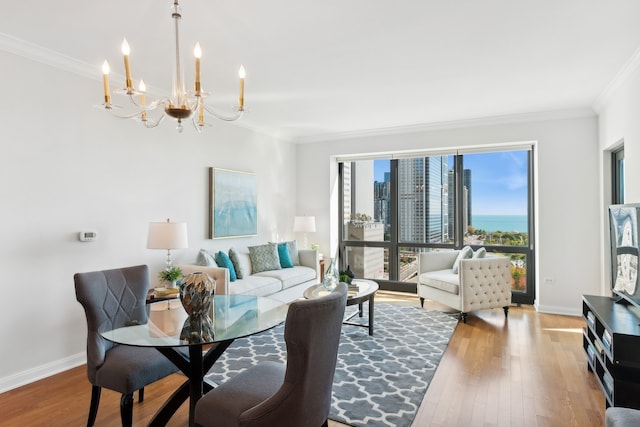 living room featuring hardwood / wood-style floors, ornamental molding, and an inviting chandelier