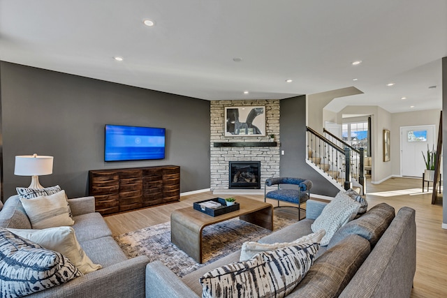 living room featuring light hardwood / wood-style floors and a fireplace