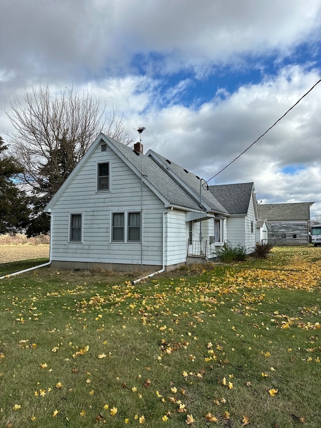 view of side of home featuring a lawn