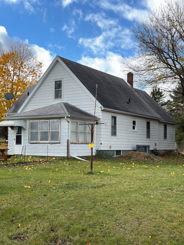 back of property with a lawn