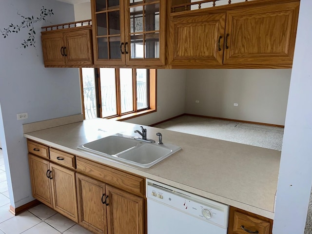 kitchen with sink, white dishwasher, and light tile patterned floors