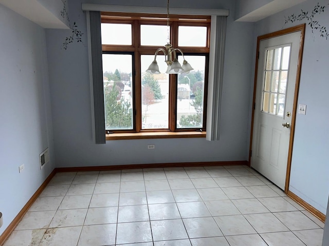 interior space featuring light tile patterned floors and a notable chandelier