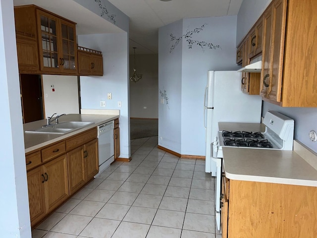 kitchen with light tile patterned floors, white appliances, and sink