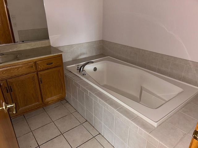 bathroom with vanity, tiled bath, and tile patterned floors