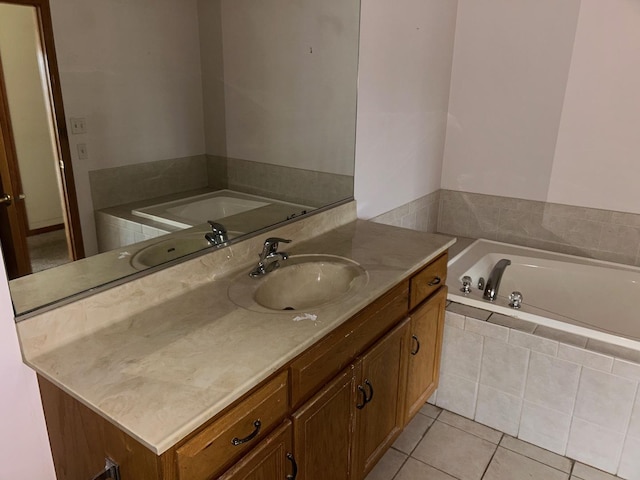 bathroom with vanity, tile patterned floors, and tiled tub