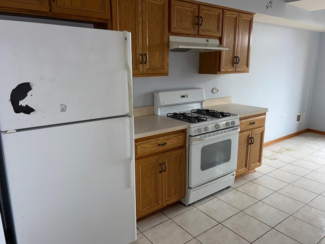 kitchen with light tile patterned floors and white appliances