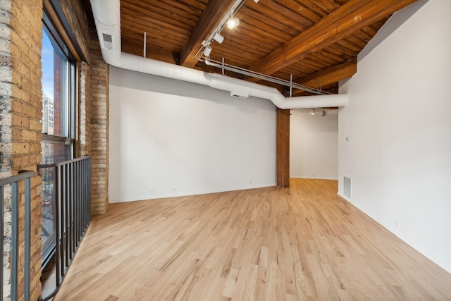 unfurnished living room featuring beam ceiling, wooden ceiling, light hardwood / wood-style floors, and track lighting