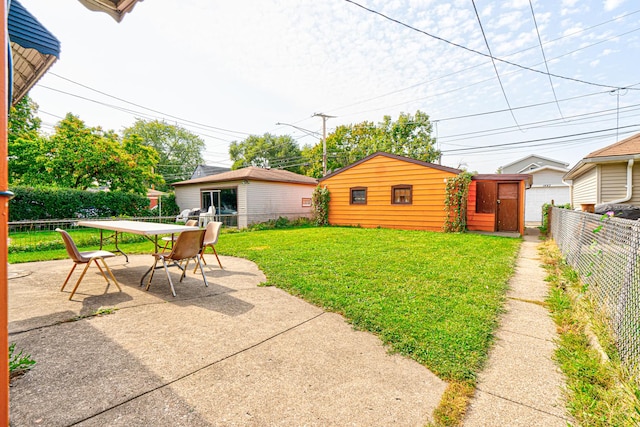 view of yard with a storage unit and a patio area