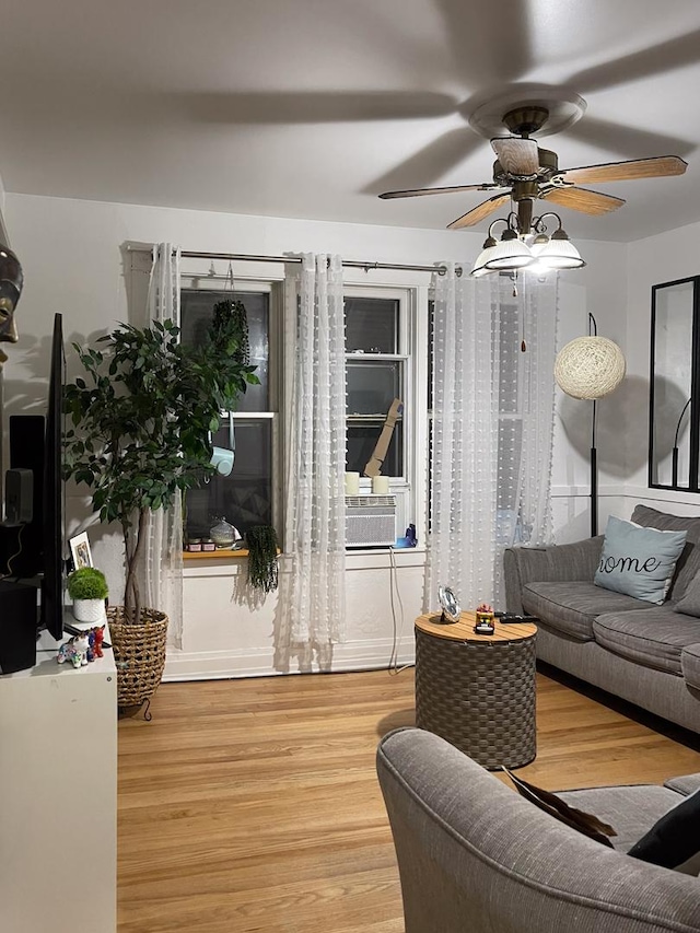 living room with ceiling fan, cooling unit, and wood-type flooring