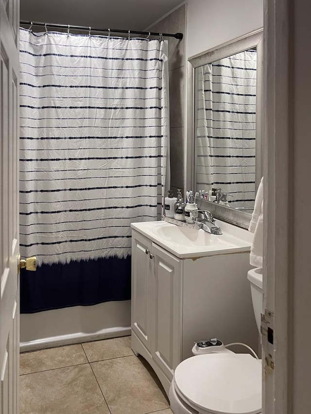 bathroom featuring toilet, vanity, tile patterned floors, and walk in shower