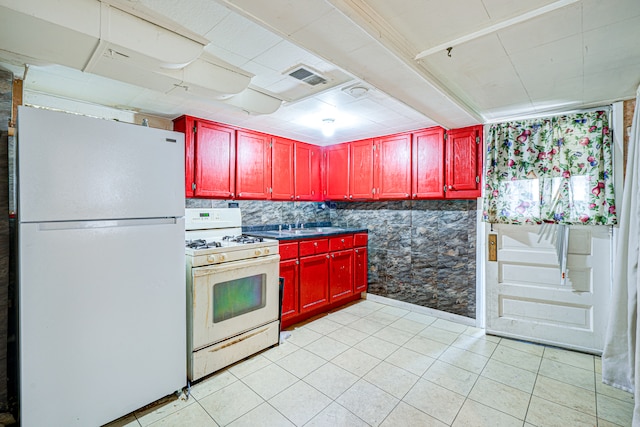 kitchen with light tile patterned floors and white appliances