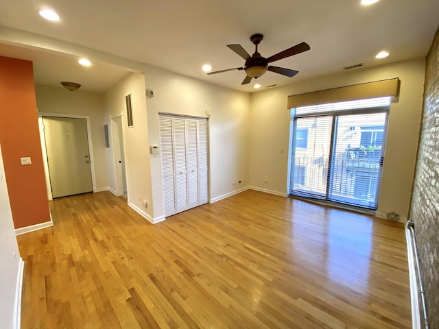 unfurnished bedroom with ceiling fan, a closet, and light hardwood / wood-style floors