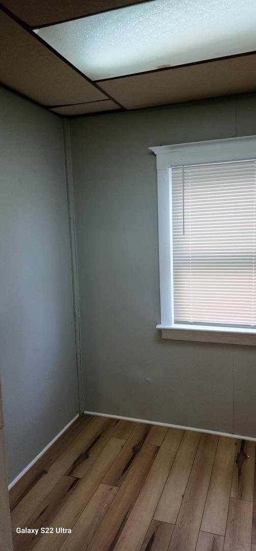 8350 S Muskegon Ave, Chicago, IL 60617 - spare room with light wood-style floors and baseboards