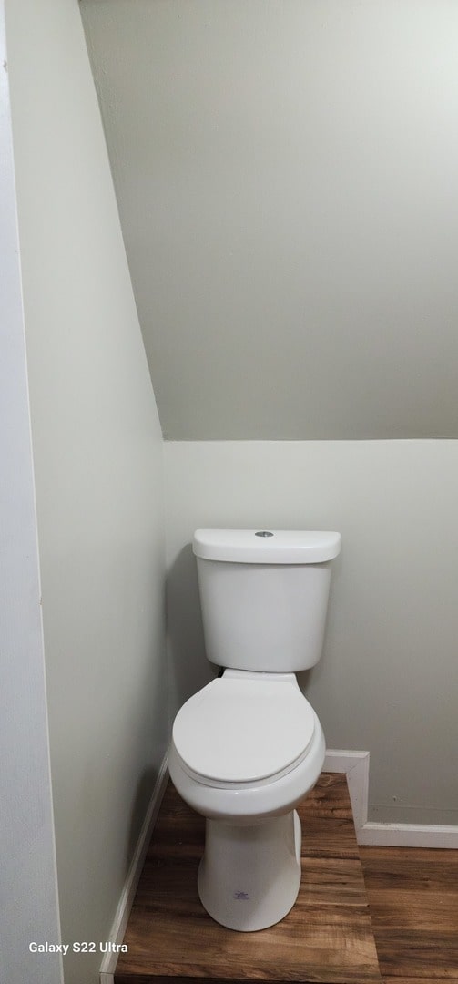 bathroom featuring hardwood / wood-style floors and toilet