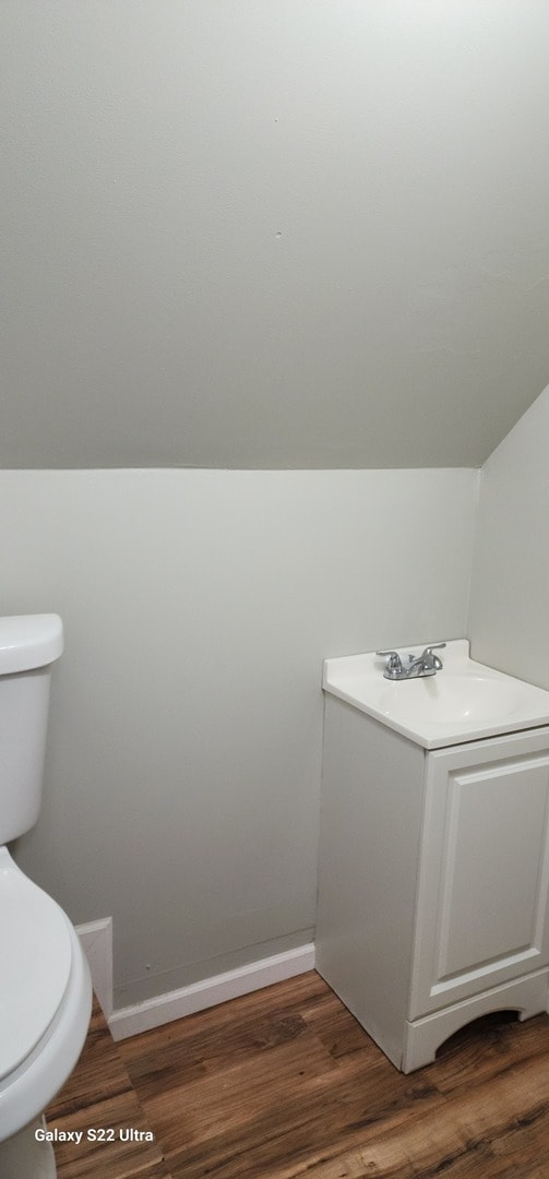 bathroom with hardwood / wood-style floors and toilet