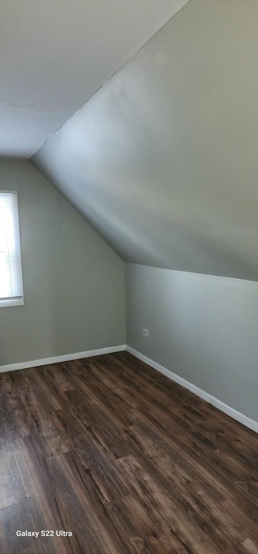 8350 S Muskegon Ave, Chicago, IL 60617 - additional living space featuring vaulted ceiling, dark wood-style flooring, and baseboards
