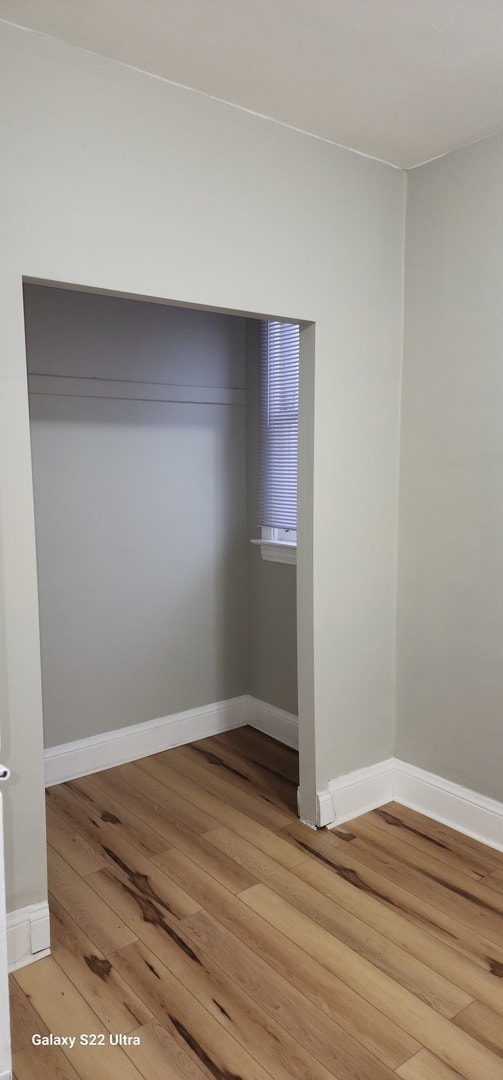 empty room with hardwood / wood-style floors