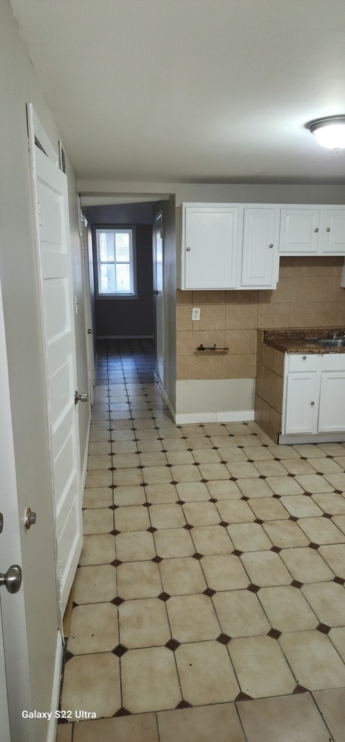 kitchen featuring decorative backsplash and white cabinetry