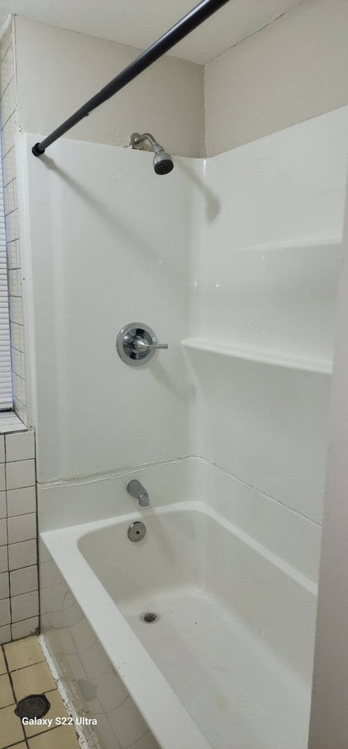 bathroom with tile patterned flooring and tile walls