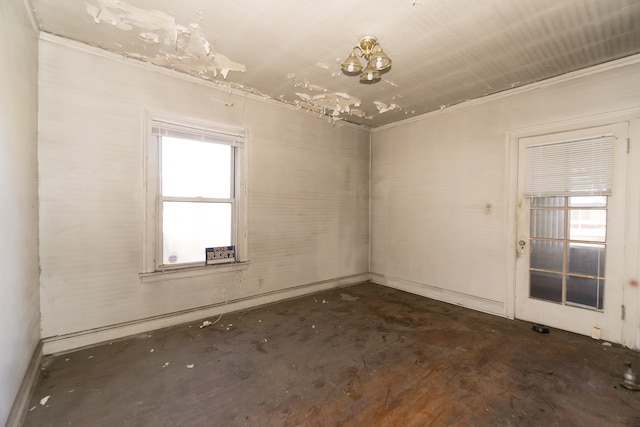 empty room with an inviting chandelier and ornamental molding