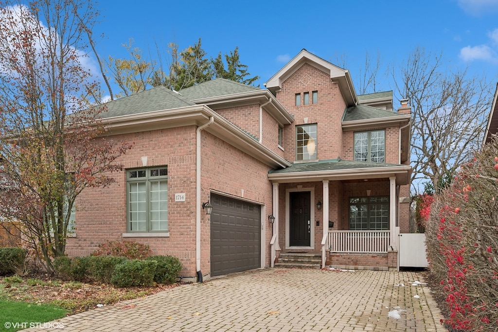 view of front of property featuring a porch and a garage