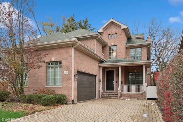 view of front of property featuring a porch and a garage