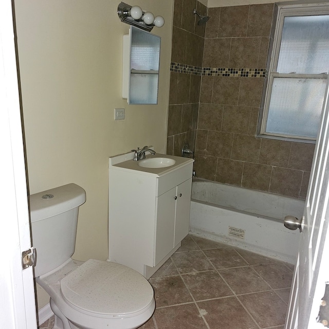 full bathroom featuring tile patterned floors, vanity, toilet, and tiled shower / bath