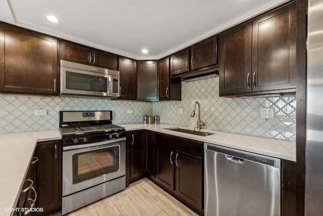 kitchen with decorative backsplash, sink, stainless steel appliances, and dark brown cabinets