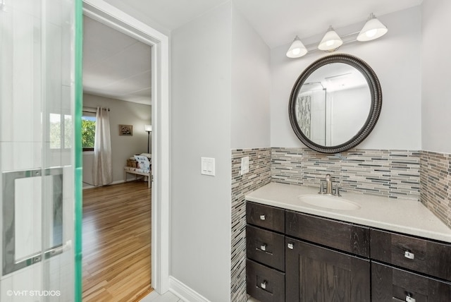 bathroom featuring backsplash, vanity, and hardwood / wood-style flooring